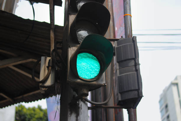 istock green traffic light with blurred background in a crosswalk. Traffic control and regulation concept 1366471229