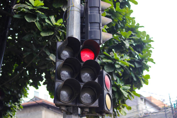 istock Red traffic light with blurred background in a crosswalk. Traffic control and regulation concept 1366471245