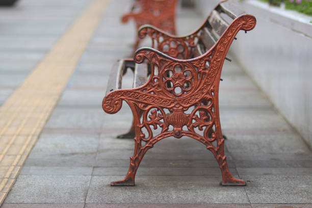 Antique Bench with blurred background on a sidewalk in Bandung City