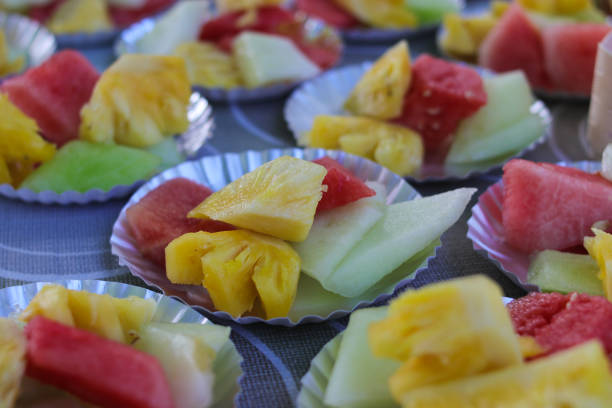 istock Different fresh fruits slices on small plates on a wedding buffet table 1366473992