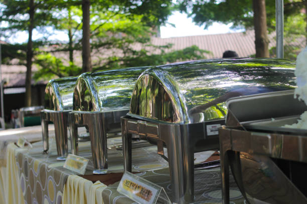 istock a group of Empty buffets with blurred background is being set up for an outdoor wedding concept. Catering and Garden party wedding concept background 1366474218