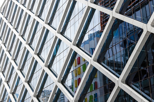 Closeup modern office building with reflection, abstract background with copy space, full frame horizontal composition