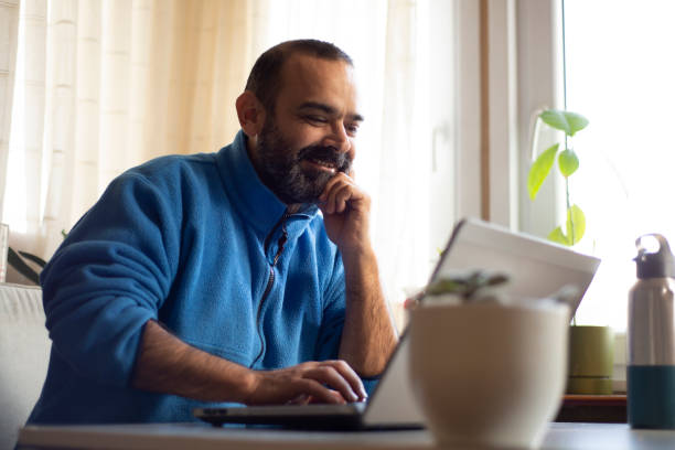 istock Male entrepreneur working on laptop at desk in modern office 1366477427