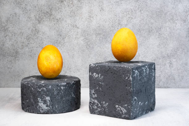 istock Yellow Easter eggs on grey podium or pedestal. Natural coloring Easter eggs with turmeric powder in yellow color 1366478712