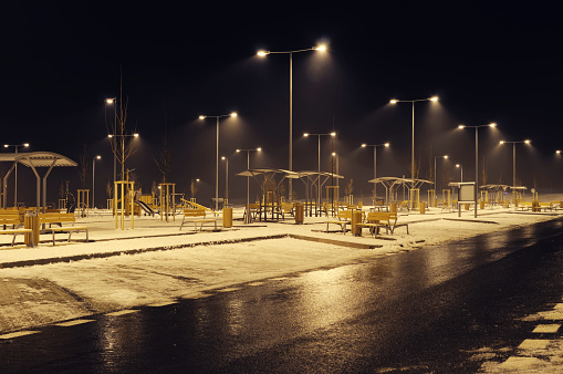 Empty gas station car park at night