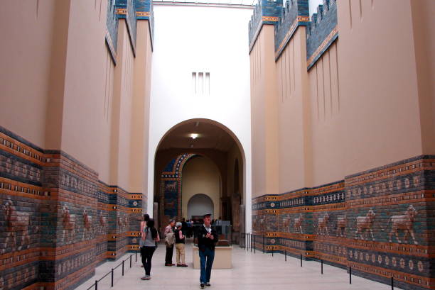 Visitors in the reconstructed ancient Babylonian Processional Way, leading to Ishtar Gate,  with Mesopotamian Lions Panels, in the in the Pergamon Museum, Berlin, Germany