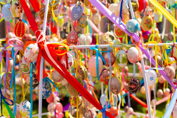 istock A composition of colorful Easter eggs handing with the multi colored ribbons. A bright sunny photo 1366485305