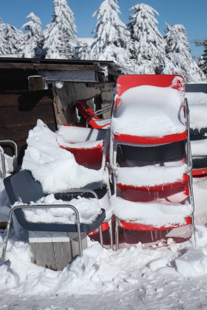 istock Snow Covered Chairs Stack On Each Other At The Mountain Coffee Shop 1366485323