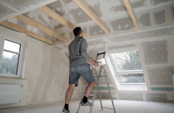 istock Man plastering drywall in a private house. 1366488320
