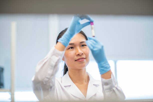 istock Female Laboratory Technician Checking a Blood Vial Sample 1366488400