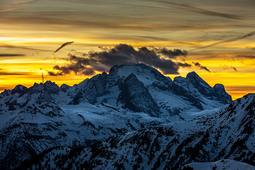 Scenic sunset behind Mount Marmolada as seen from Passo Giau, in Cortina d'Ampezzo in the italian dolomites