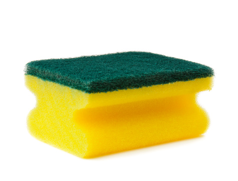 Yellow kitchen sponge isolated on a white background.