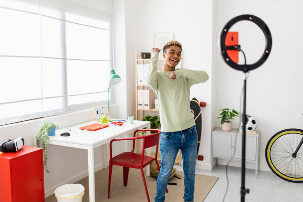 istock Young man recording dance video tutorial for social media with phone in room 1366492956