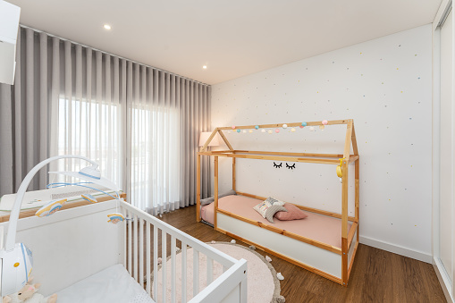 Baby bedroom with crib and small bed