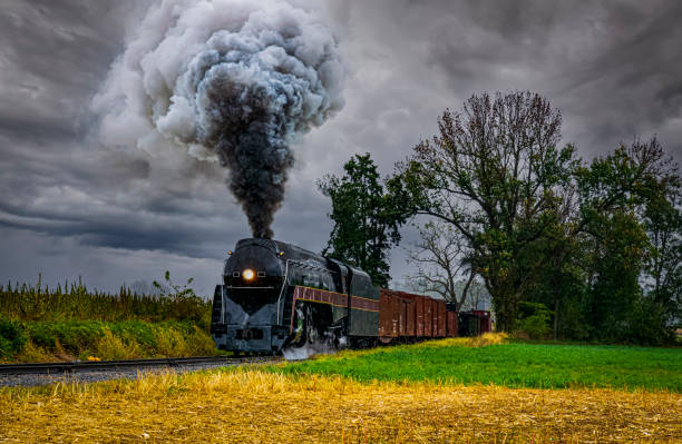 An Antique Restored Steam Freight Train Approaching Head on Blowing Smoke and Steam