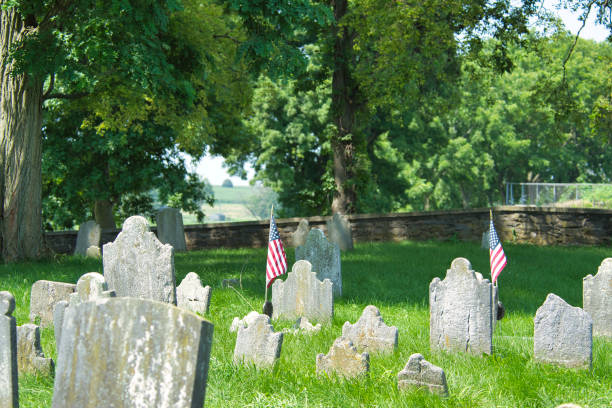 istock Old Cemetery Sits in the Woods With Head Stones Falling 1366494133