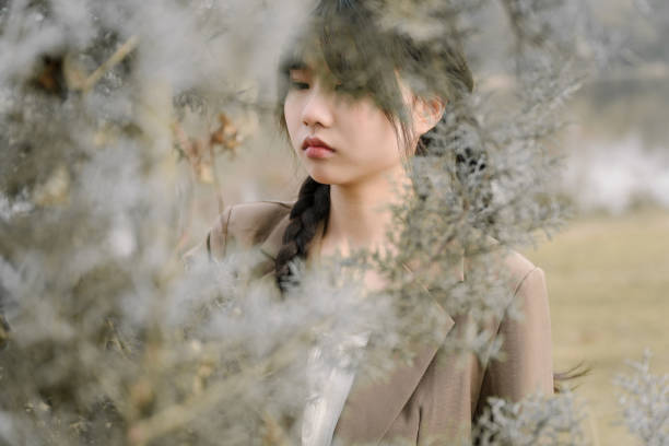 istock Asian women next to trees 1366494940