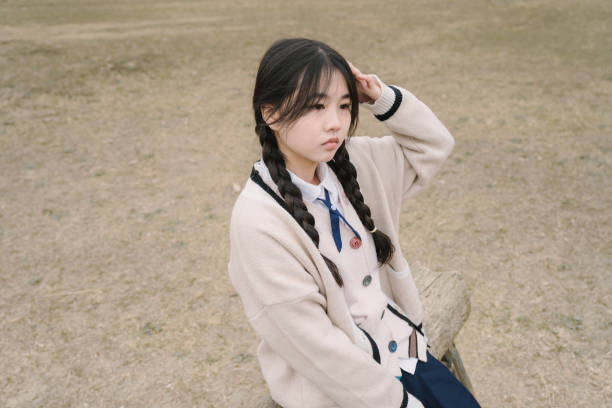 istock Asian women resting on stone benches 1366495662