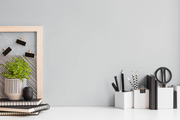 istock Desk at home office with supplies and wall copy space. Minimalistic workspace. 1366497896