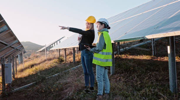 istock Female engineers working in solar power plant. Teamwork. Renewable energy systems. Solar city. 1366499730
