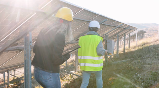 istock Female engineers working in solar power plant. Teamwork. Renewable energy systems. Solar city. 1366499737