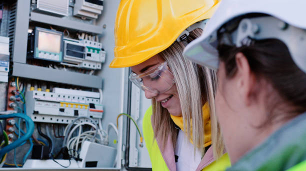 istock Female engineers working in solar power plant. Teamwork. Renewable energy systems. Solar city. 1366499743