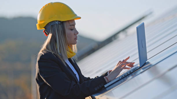 istock Female engineer working in solar power plant. Renewable energy systems. Solar city. 1366499759