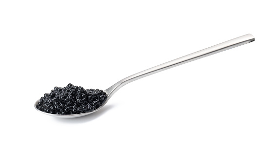 caviar de pez espátula negro en una cuchara de metal sobre un fondo blanco aislado photo