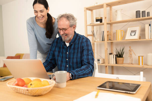 istock Mature man and his wife using laptop at home 1366501677