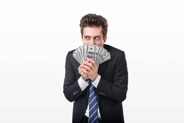 greedy businessman with dollar banknotes making evil plans - greed imagens e fotografias de stock