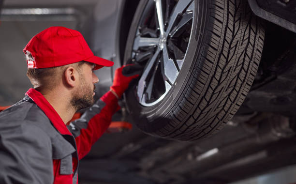 istock Male technician checking vehicle wheel 1366505441