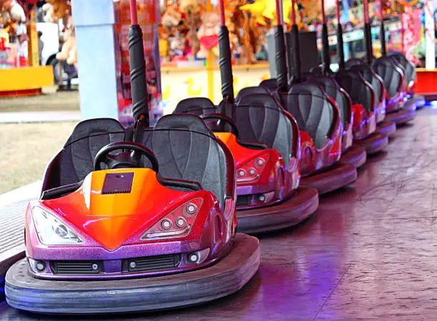 Photo of A line of bumper cars at an amusement fair
