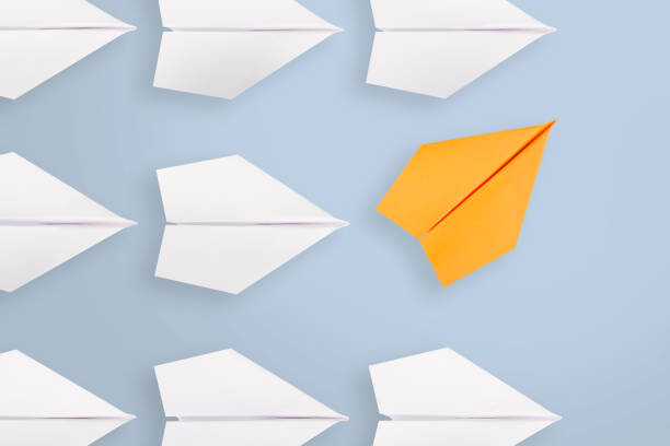istock Change concepts with yellow paper airplane leading among white 1366507803