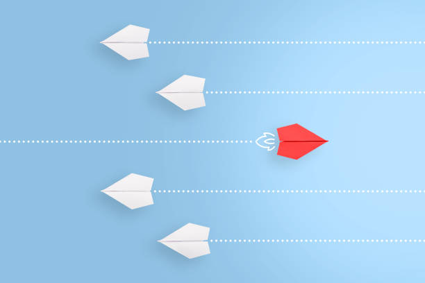 istock Change concepts with red paper airplane leading among white 1366508094