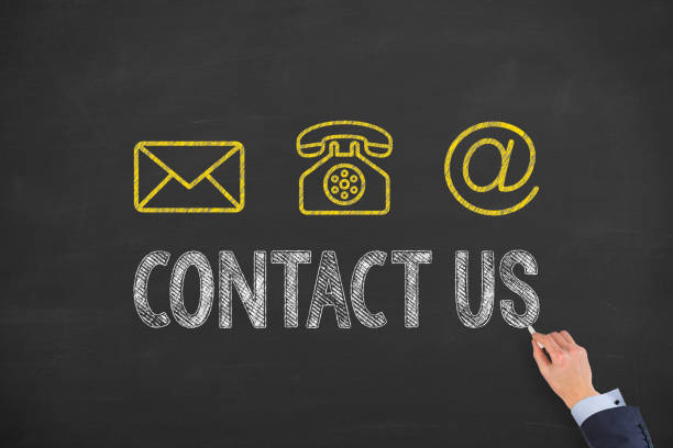 istock Human Hand Drawing Contact Us on Blackboard 1366508124
