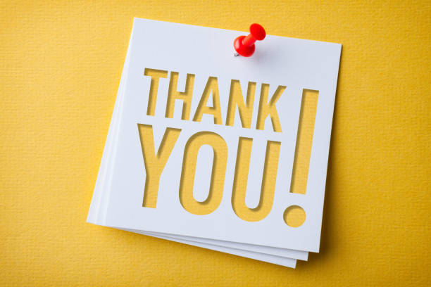 White Sticky Note With Thank You And Red Push Pin On Yellow Background stock photo