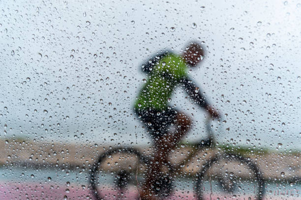 istock A person riding a bicycle in the rain. 1366511221