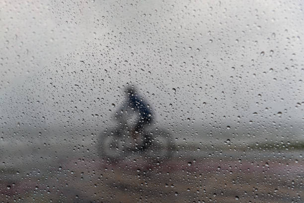 istock A person riding a bicycle in the rain. 1366511223