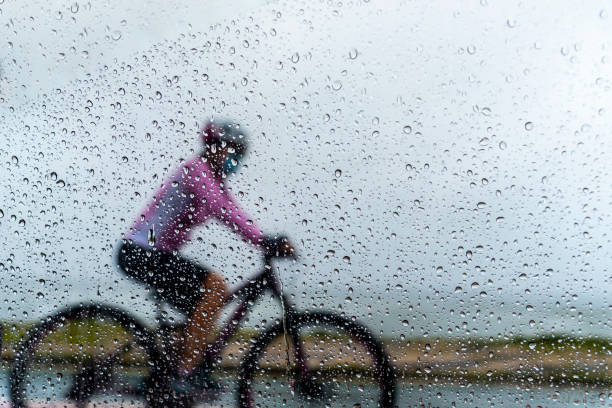 istock A person riding a bicycle in the rain. 1366511225