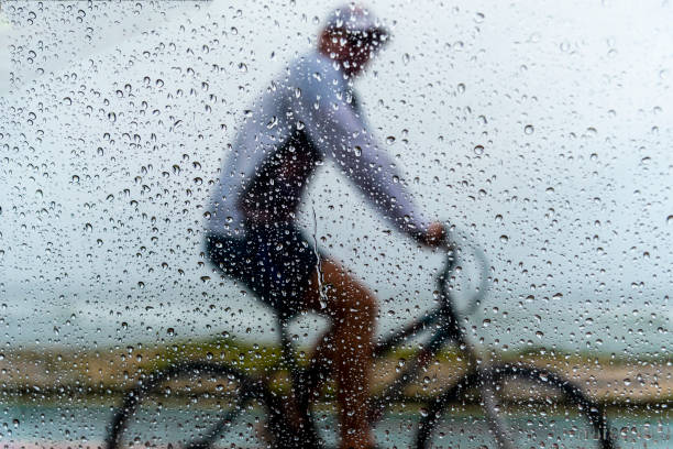 istock A person riding a bicycle in the rain. 1366511232