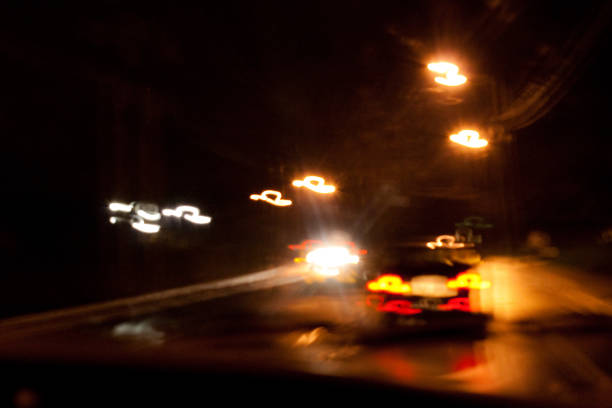 Abstract of car tail lights at night on highway with headlights of oncoming traffic