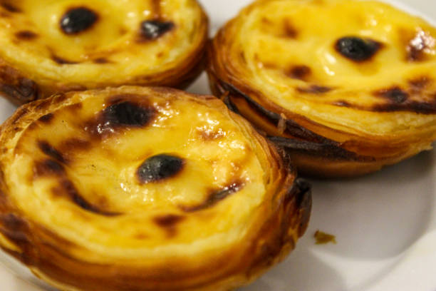 Typical Portuguese custard pies, Pastel de Nata or Pastel de Belem. A close-up of traditional Portuguese custard pastries in traditionl caffe - restorant. Pastel de nata. Pastéis de Belém. Typical Portuguese custard pies, Pastel de Nata or Pastel de Belem. A close-up of traditional Portuguese custard pastries in traditionl caffe - restorant. Pastel de nata. Pastéis de Belém. pasteis de belem stock pictures, royalty-free photos & images