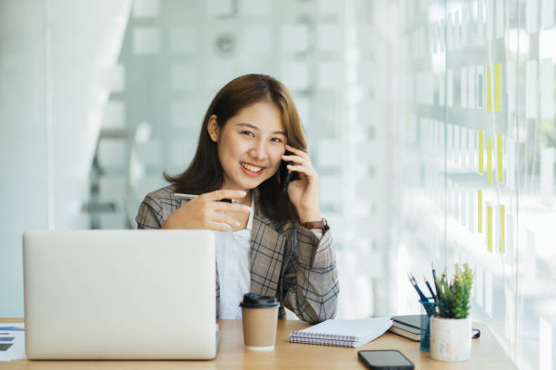 istock Laughing female entrepreneur talking with a client on her cellphone 1366527822