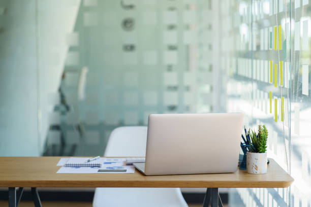 istock businesswoman with laptop computer and papers working at office. 1366527844