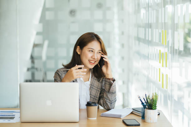 istock Laughing female entrepreneur talking with a client on her cellphone 1366528063