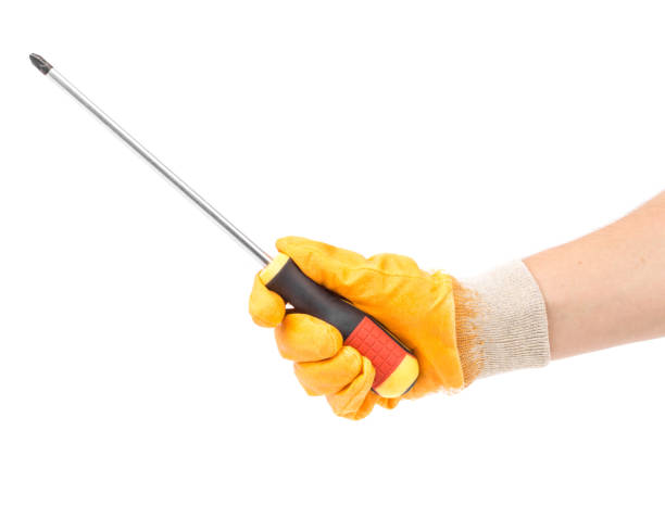 istock Hand in glove holds screwdriver. 1366531671