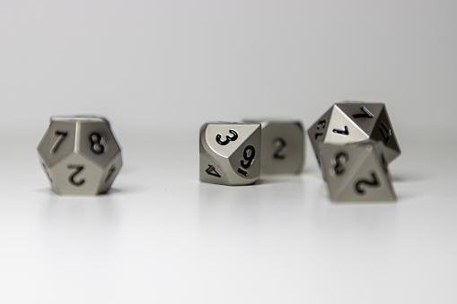 Assorted fantasy role playing game dice sit against a white background.