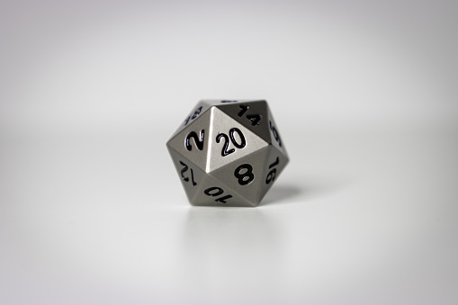 A centered 20-sided fantasy role playing game dice against a white studio background with a slight vignette.