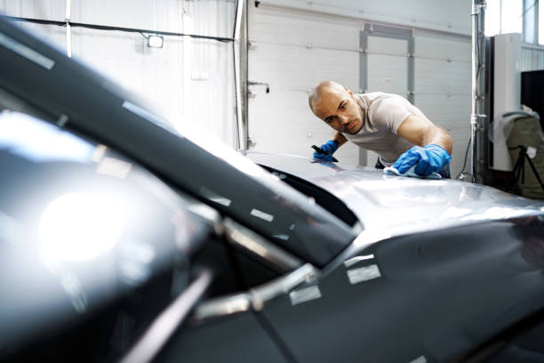 istock African American man car service worker applying nano coating on a car 1366536335