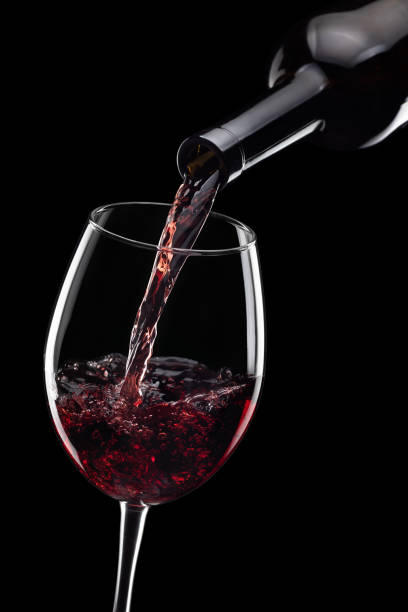 istock red wine pouring in glass from bottle isolated 1366536436
